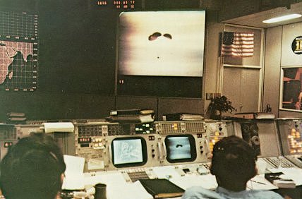 A photo of two flight controllers at Mission Control Center