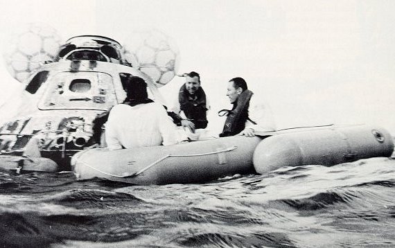 A photo of three astronauts on a life raft