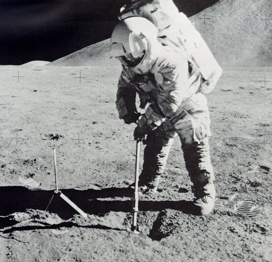 A photo of astronaut Irwin scooping samples