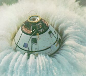 A photo of the command module floating in water