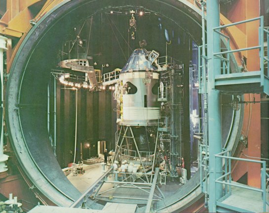A photo of the command and service modules in a huge test chamber