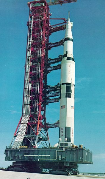A photo of a crawler carrying a space vehicle and its Mobile Launcher