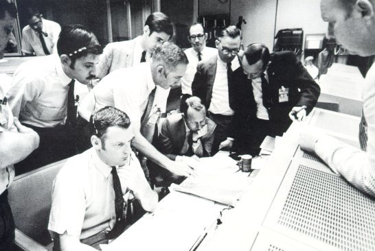 A photo of Mission Control directors in a discussion
