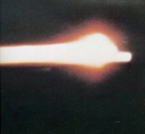 A photo of Apollo 8 command module blazing across the sky