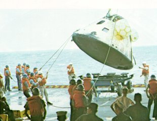 A photo of Apollo 8 command module is hoisted onto USS Yorktown