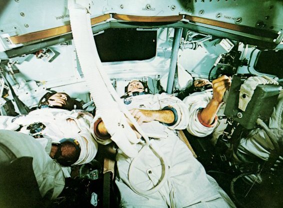 A photo of Apollo astronauts,Anders,Lovell, and Borman inside a simulator