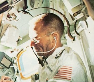 A photo of Cunningham, lunar module pilot on Apollo 7 making notes